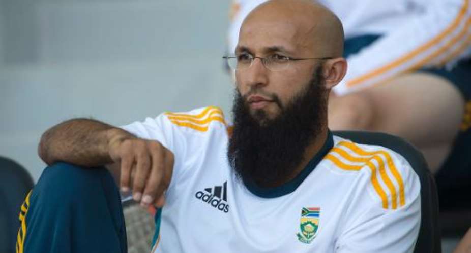 South Africa batsman Hashim Amla watches the team's match against Pakistan on the fourth day of their first Test in Abu Dhabi on October 17, 2013.  By  AFPFile