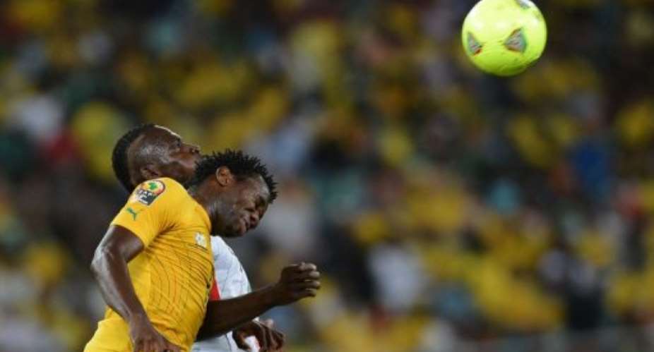 Bongani Khumalo foreground heads the ball against Mali in Durban on February 2, 2013.  By Francisco Leong AFPFile