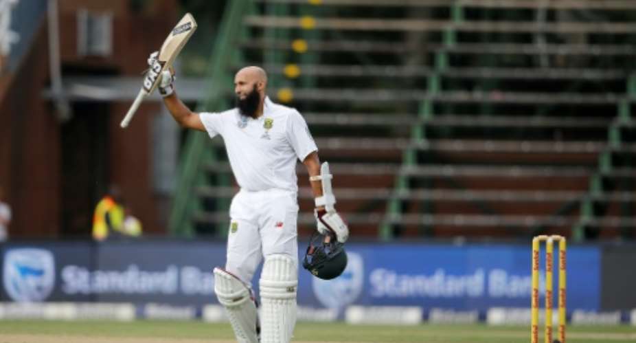 South Africa batsman Hashim Amla celebrates his century in his hundredth Test during the third match against Sri Lanka at Wanderers Cricket Stadium in Johannesburg on January 12, 2017.  By Marco LONGARI AFP