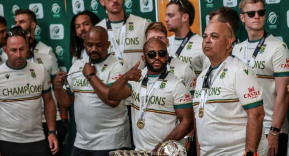 South Africa captain Temba Bavuma (C) with teammates after arriving in Johannesburg.  By Phill Magakoe (AFP)