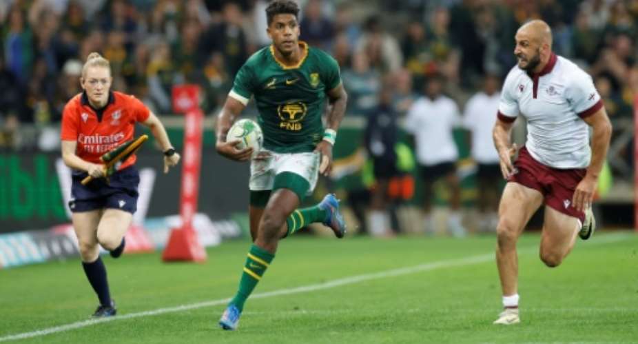 South Africa centre Canan Moodie (L) runs with the ball against Georgia in Mbombela.  By PHILL MAGAKOE (AFP)
