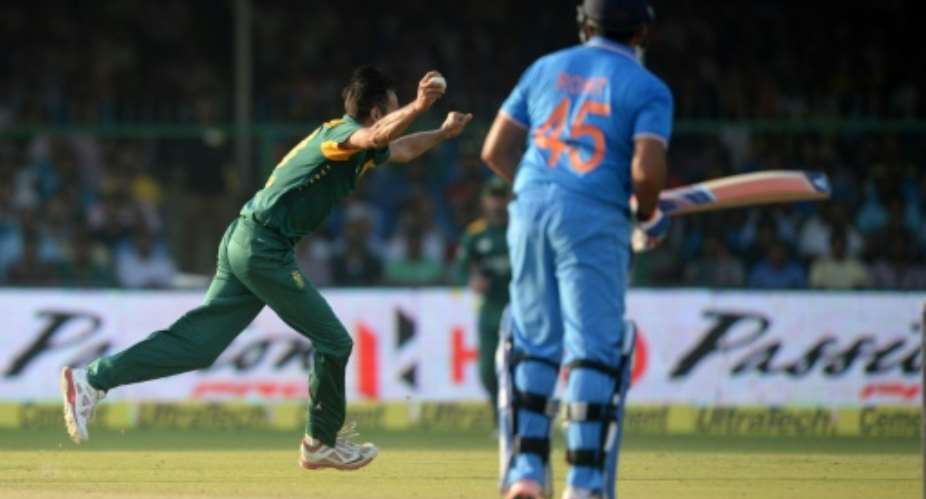 South Africa's Imran Tahir L celebrates after taking a catch off his own bowling to dismiss India's Rohit Sharma for 150 during the first one-day international at Green Park Stadium in Kanpur on October 11, 2015.  By Prakash Singh AFP