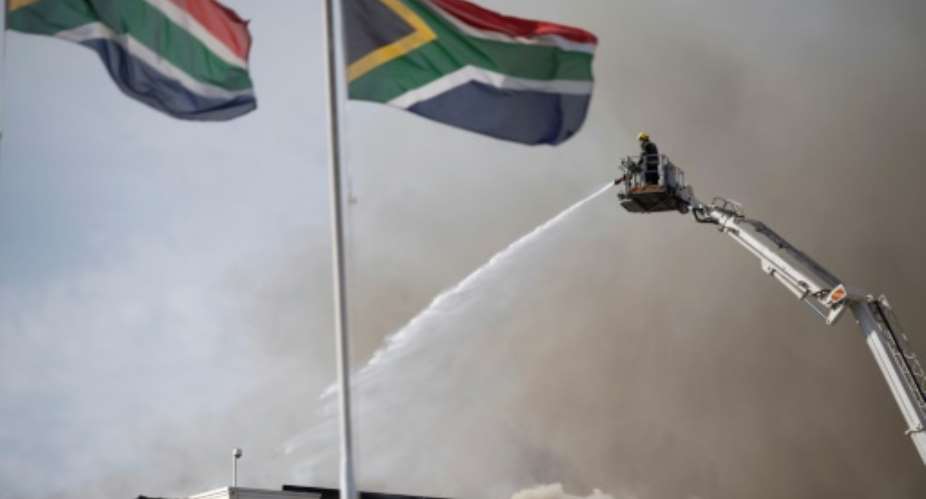 South Africa firefighters fight the blaze at the National Assembly in 2022.  By RODGER BOSCH AFPFile