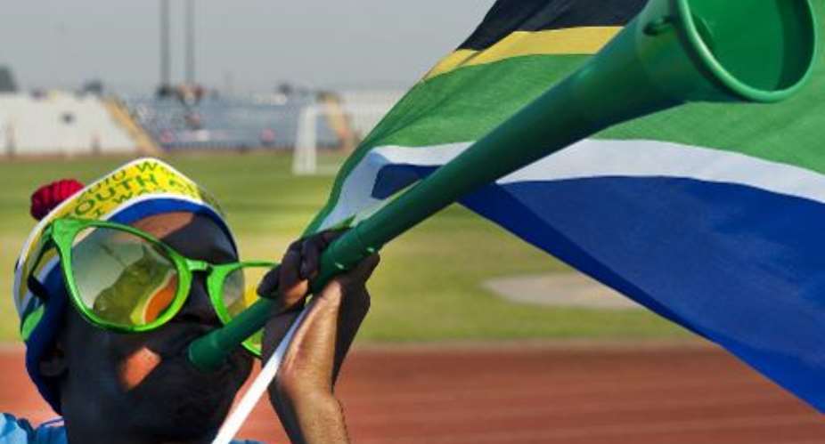 A Soweto resident is seen playing the vuvuzela at Johannesburg's Dobsonville stadium on June 3, 2010 when South Africa was hosting the World Cup.  By Antonio Scorza AFPFile