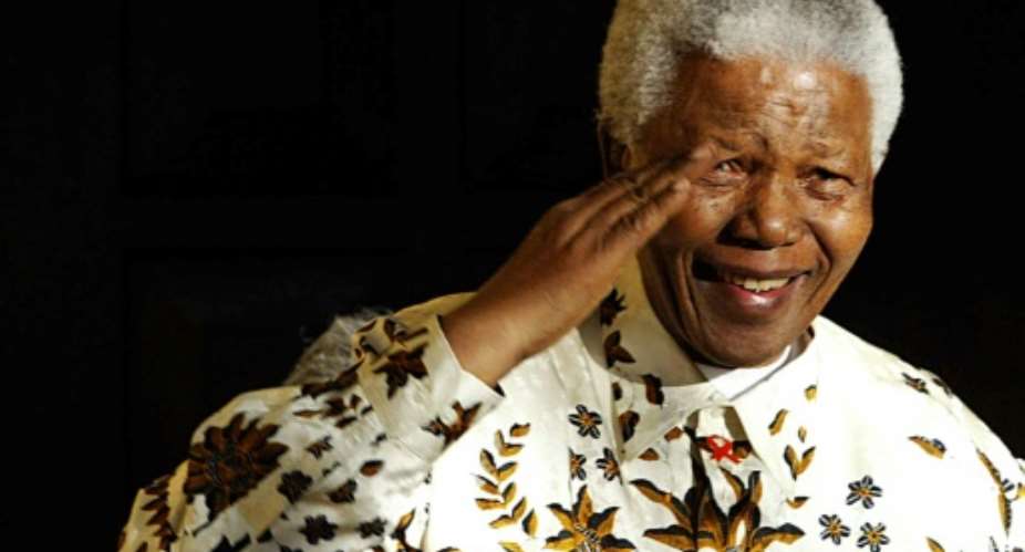 South Africa marks 10 years since the death of Nelson Mandela -- seen here saluting a military band that played for his 85th birthday in 2003.  By Alexander JOE (AFP/File)