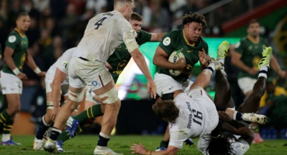 South Africa prop Zach Porthen runs with the ball against England at Ellis Park in Johannesburg..  By PHILL MAGAKOE (AFP)