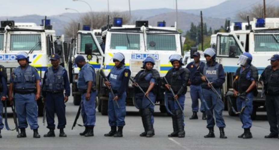 South African police attend a recent miners' protest. The crime rate in the country is falling.  By Alexander Joe AFPFile