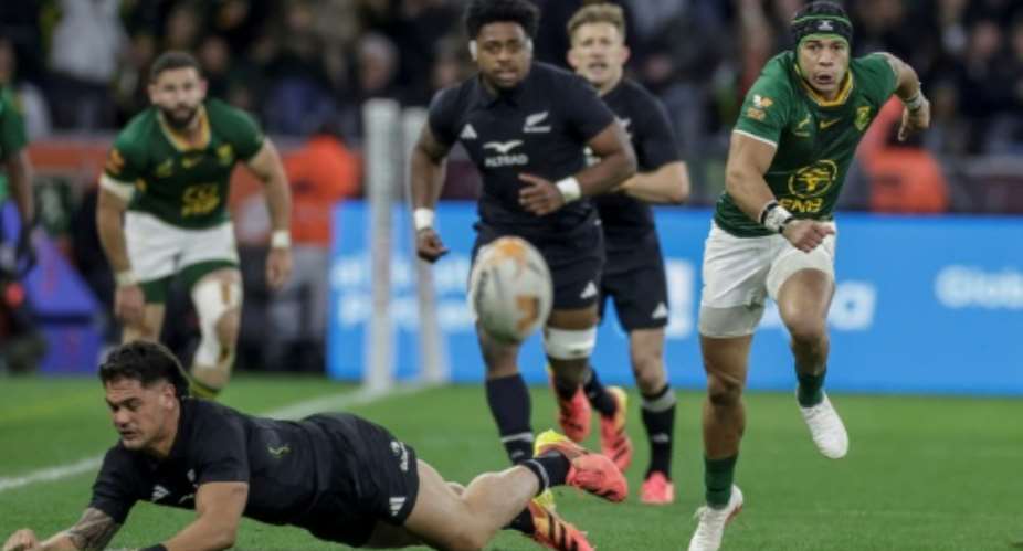 South Africa wing Cheslin Kolbe chases after the ball against New Zealand in Cape Town.  By GIANLUIGI GUERCIA (AFP)