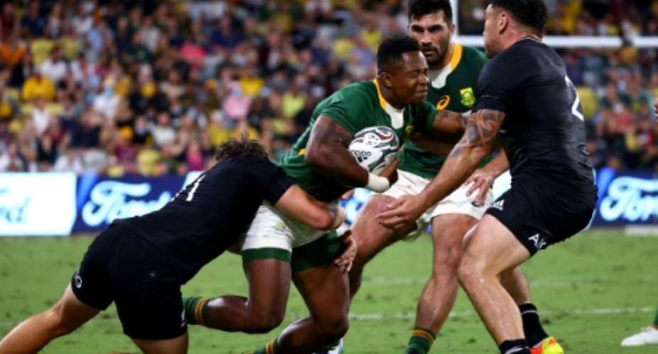 South Africa winger Sibusiso Nkosi (C) is tackled in a 2021 Rugby Championship match against New Zealand..  By Patrick HAMILTON (AFP)