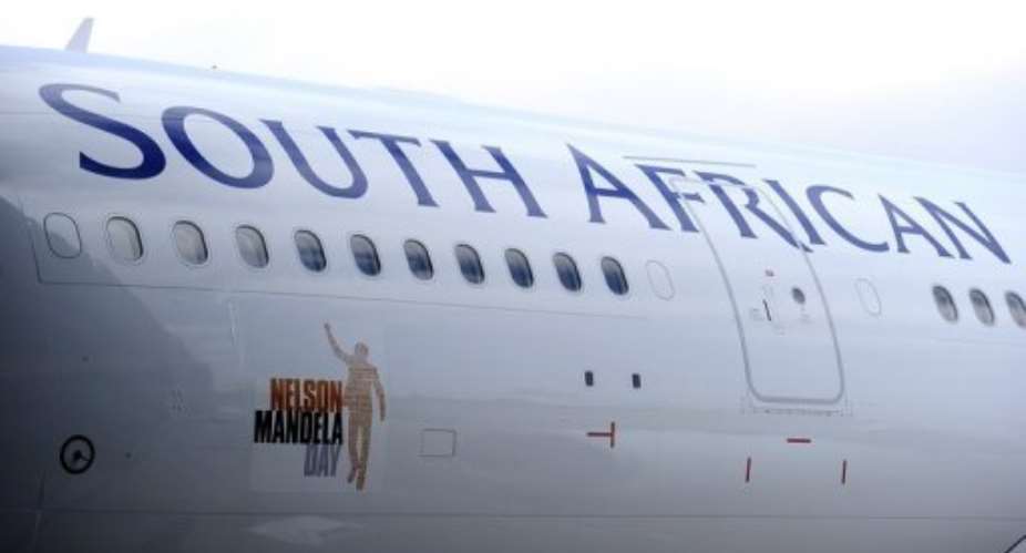 The first South African Airways jet emblazoned with the Nelson Mandela Day logo at a Johannesburg airport.  By Stephane de Sakutin (AFP)