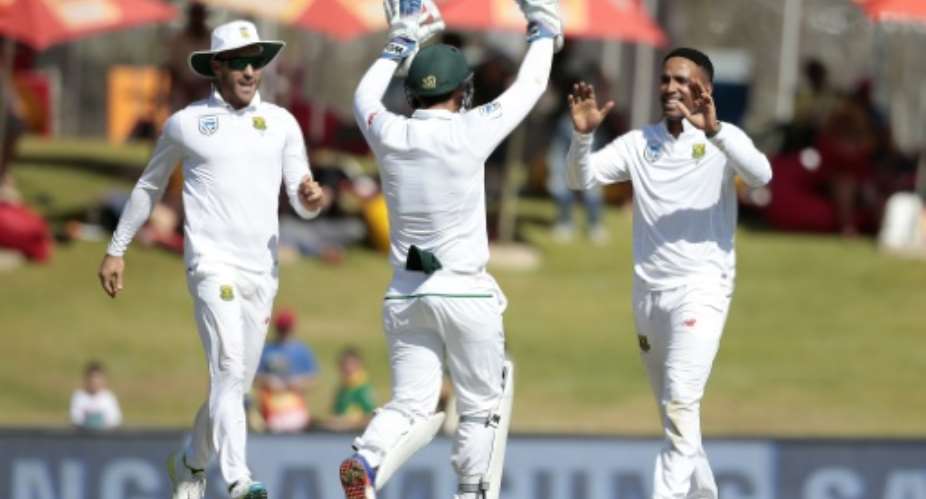 South African bowler Dane Piedt right celebrates the dismissal of New Zealand batsman BJ Watling Unseenon the fourth day of their second Test match in Centurion, South Africa on August 30, 2016.  By Gianluigi Guercia AFP