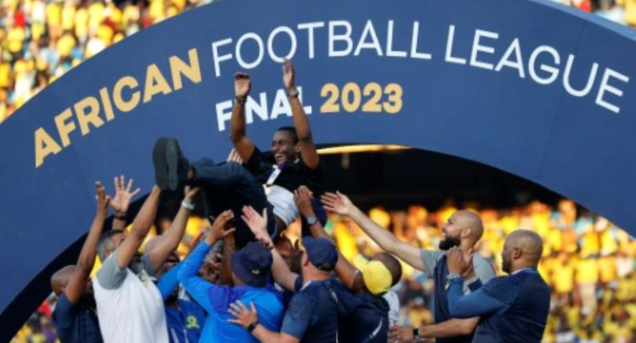 South African coach Rulani Mokwena (C) is lifted by Mamelodi Sundowns staff after winning the inaugural African Football League..  By Phill MAGAKOE (AFP)