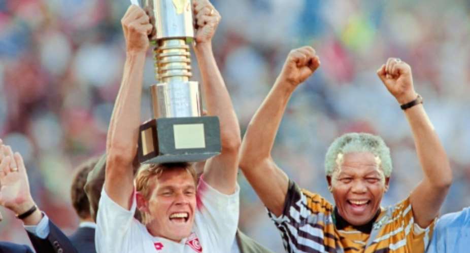 Neil Tovey celebrates with Nelson Mandela in 1996 after South Africa won the Africa Nations Cup.  By Mykel Nicolaou AFP