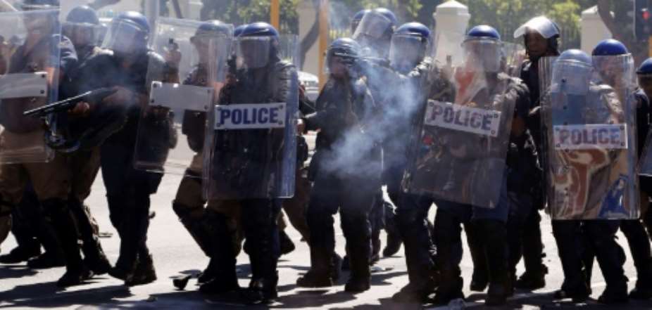 South African Police attend a protest outside Parliament in Cape Town.  By Schalk van Zuydam poolAFP