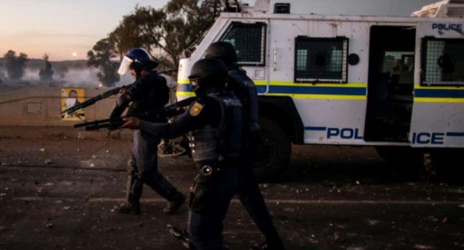 South African police fired rubber bullets and stun grenades to break up clashes between local protesters and migrants in Pretoria at a march against immigration.  By MARCO LONGARI AFPFile