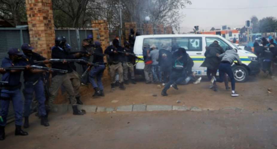 South African police officers fired tear gas and rubber bullets at protesters in a Johannesburg suburb.  By Michele Spatari AFP