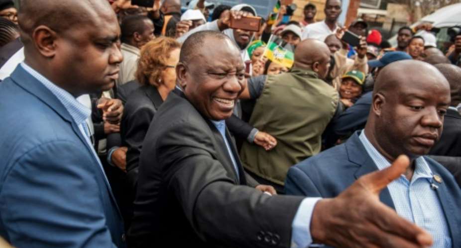 South African President Cyril Ramaphosa greeted voters before casting his ballot at a primary school in Soweto.  By Michele Spatari AFP