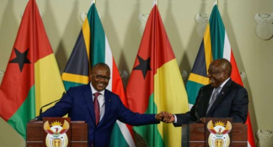 South African President Cyril Ramaphosa R praised the ECOWAS bloc for developing a 'decisive' anti-coup strategy, after talks with  Guinea-Bissau President Umaro Sissoco Embalo.  By Phill Magakoe AFP