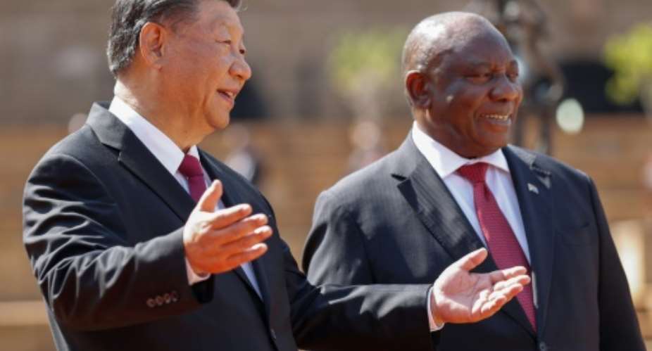 South African President Cyril Ramaphosa, right, with Chinese President Xi Jinping, who is combining a state visit with the BRICS summit.  By PHILL MAGAKOE AFP