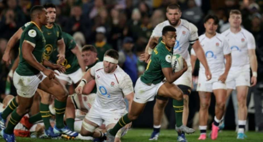 South African scrum-half Grant Williams leaves the England defence flatfooted to score..  By PHILL MAGAKOE (AFP)