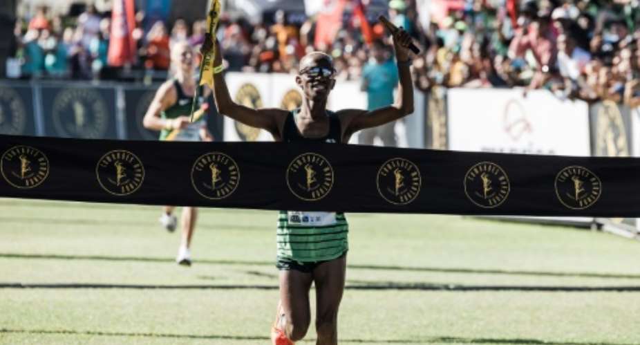 South African Tete Dijana wins the Comrades ultramarathon mens race with second-placed Piet Wiersma from the Netherlands in the background..  By RAJESH JANTILAL (AFP)