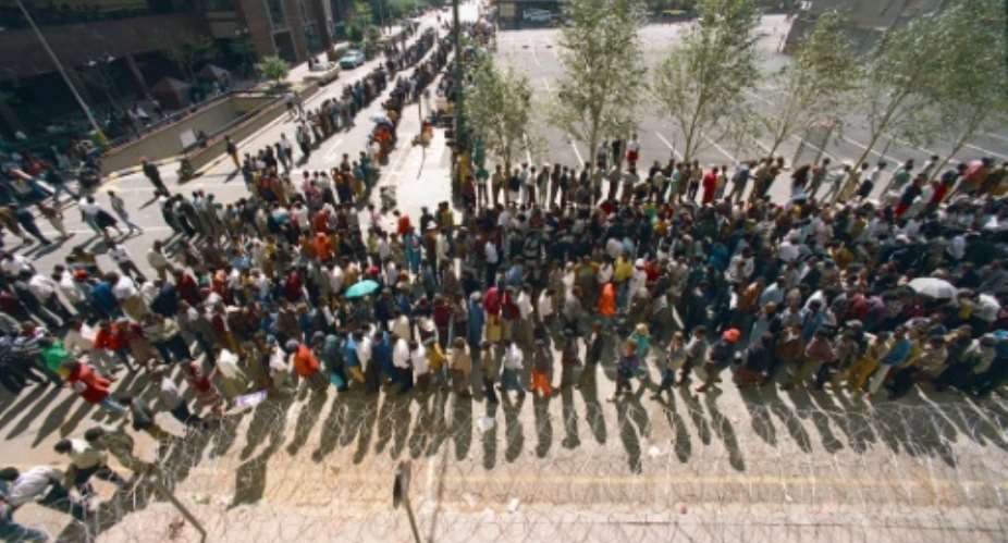 South Africans queue to cast their votes in Johannesburg on April 27, 1994, in the country's first all-race elections.  By MIKE PERSSON AFPFile