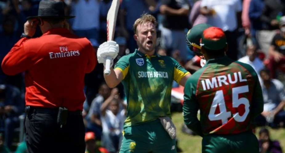 South Africa's AB de Villiers centre celebrates after scoring a century during the second one day international ODI match against Bangladesh at Boland Park in Paarl on October 18, 2017.  By RODGER BOSCH AFP
