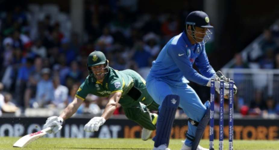 South Africa's AB de Villiers left is run out as India's MS Dhoni stumps the wicket during their ICC Champions Trophy match at The Oval in London on June 11, 2017.  By Ian KINGTON AFP