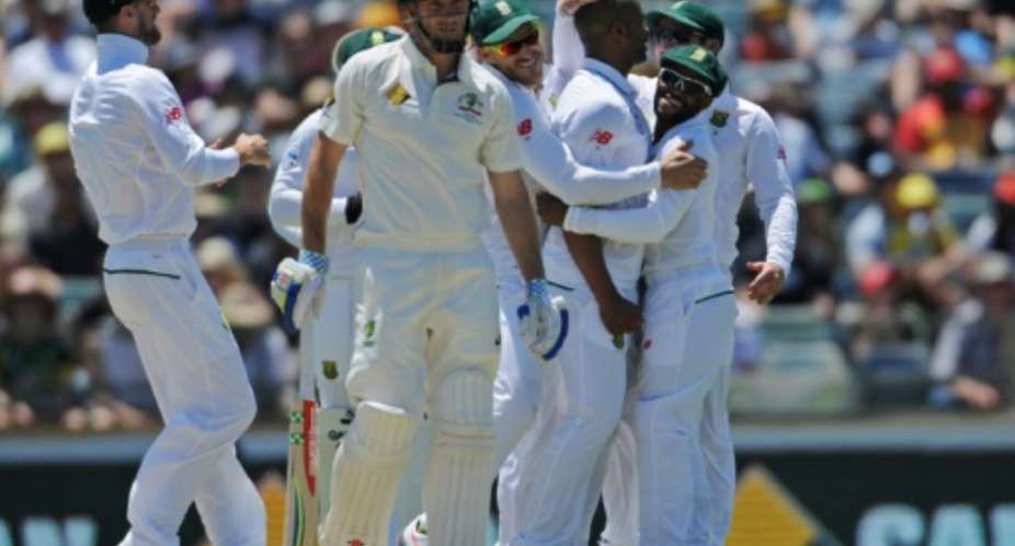 South Africa's bowler Vernon Philander 3rd R is embraced by teammates after making a successful appeal for an LBW decision against Australia's Shaun Marsh C on day two of their first Test match, in Perth, on November 4, 2016.  By Greg Wood AFP