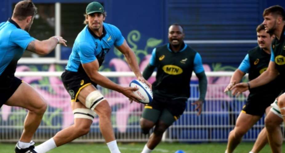 South Africa's captain and lock Eben Etzebeth passes the ball during a training session at the Stade du Saut du Loup in Paris, on November 13, 2017.  By Lionel BONAVENTURE AFP