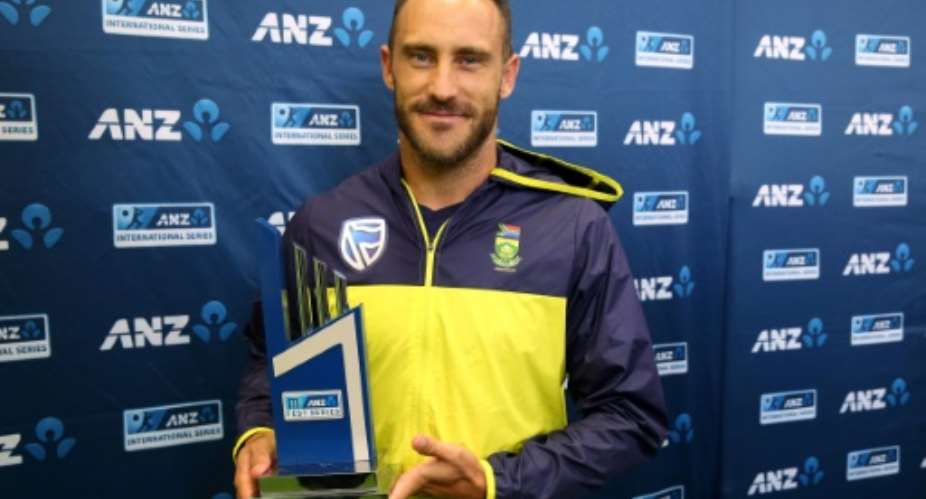 South Africa's captain Faf du Plessis holds the trophy on the day five of their third Test match against New Zealand, after the last day's play was called off due to rain, at Seddon Park in Hamilton, on March 29, 2017.  By Michael Bradley AFP