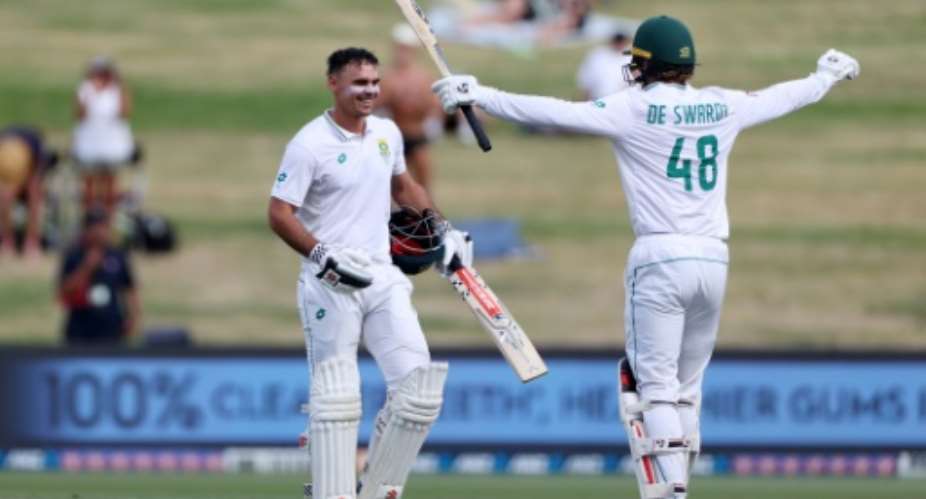 South Africa's David Bedingham left is congratulated after reaching his hundred by Ruan de Swardt.  By Fiona Goodall AFP