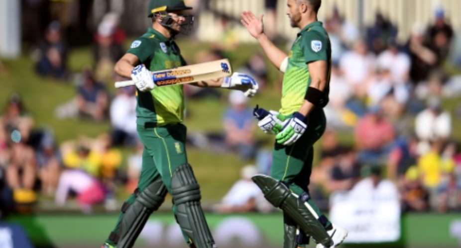 South Africa's David Miller L and Faf du Plessis celebrate scoring their centuries against Australia during the third one-day international.  By WILLIAM WEST AFP