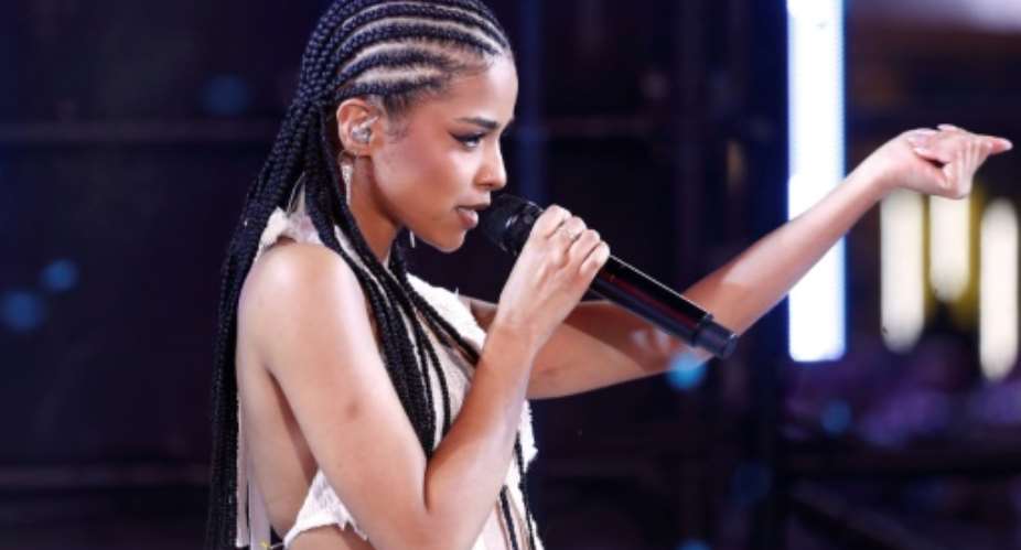 South Africa's Grammy-winning singer Tyla says she is heartbroken to have had to cancel her maiden world tour because of an injury.  By John LAMPARSKI AFP