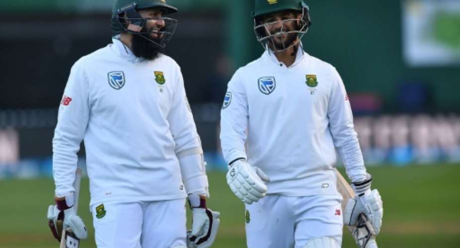 South Africa's Hashim Amla L and Jean-Paul Duminy celebrate after winning their 2nd Test against New Zealand, at the Basin Reserve in Wellington, on March 18, 2017.  By Marty Melville AFP