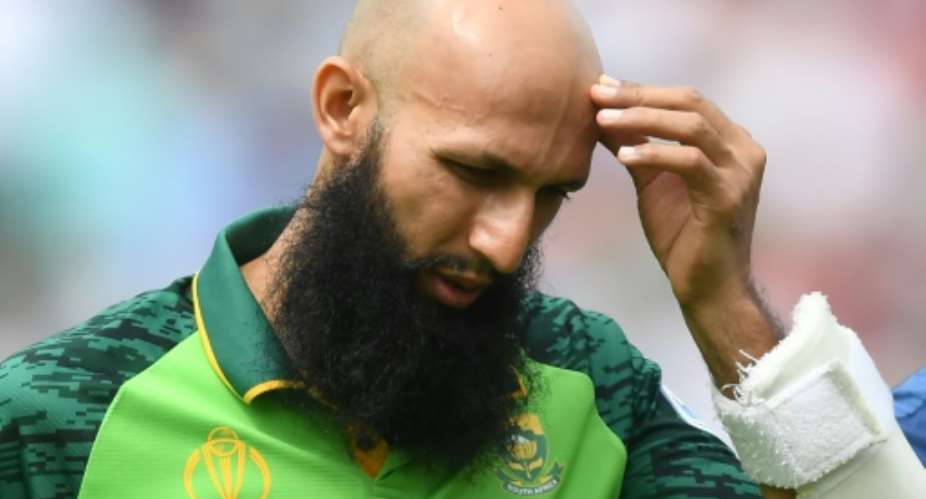 South Africa's Hashim Amla walks back to the pavilion after being hit on the head by England's Jofra Archer in the opening match of the World Cup.  By Dibyangshu SARKAR AFP