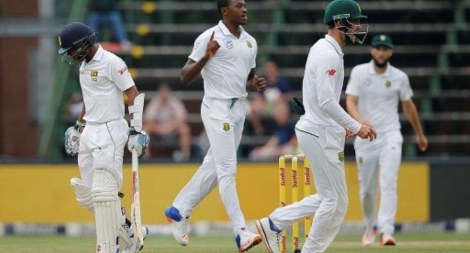 South Africa's Kagiso Rabada centre celebrates the wicket of Sri Lanka's Kusal Mendis during the third Test in Johannesburg on January 13, 2017.  By MARCO LONGARI AFP