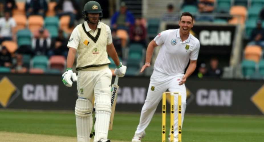 South Africa's Kyle Abbott R celebrates his first wicket of Australia's Joe Burns L on the third day's play of the second Test  on November 14, 2016.  By Saeed Khan AFP
