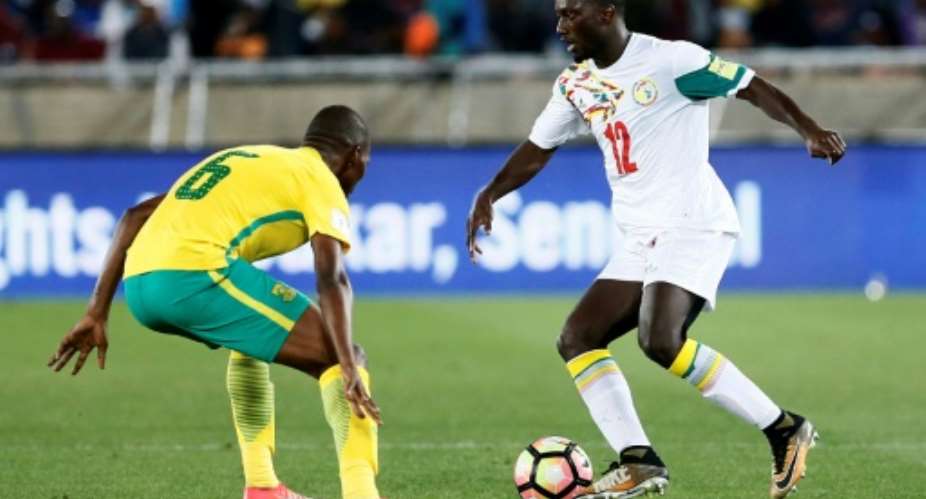South Africa's midfielder Thamsanqa Mkhize L vies for the ball with Senegal's defender Youssouf Sabaly  during the FIFA 2018 World Cup Africa Group D qualifying football match November 10, 2017.  By PHILL MAGAKOE AFPFile