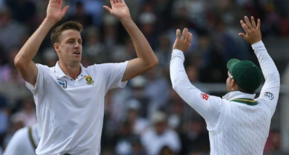 South Africas Morne Morkel (left) celebrates taking the wicket of Englands Dawid Malan on the first day of the fourth Test at Old Trafford on August 4, 2017.  By Paul ELLIS (AFP)