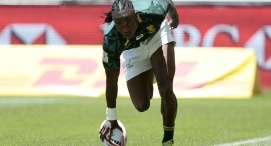 South Africas Seabelo Senatla scores a try during the World Rugby Sevens Series match against Russia on December 9, 2017 at the Cape Town Stadium.  By GIANLUIGI GUERCIA (AFP)
