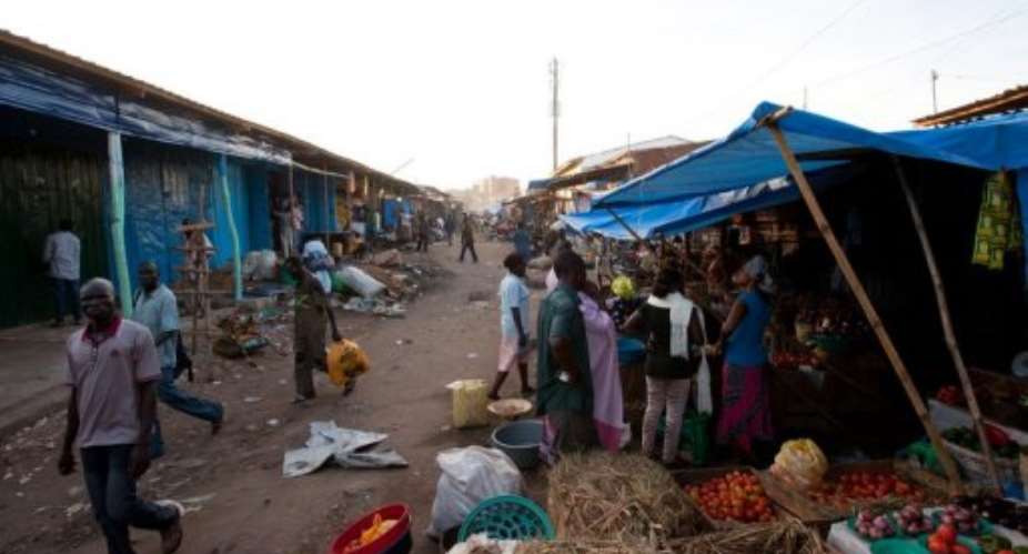 Customers and vendors talk at a market, in Juba, South Sudan, in May.  By Giulio Petrocco AFPFile