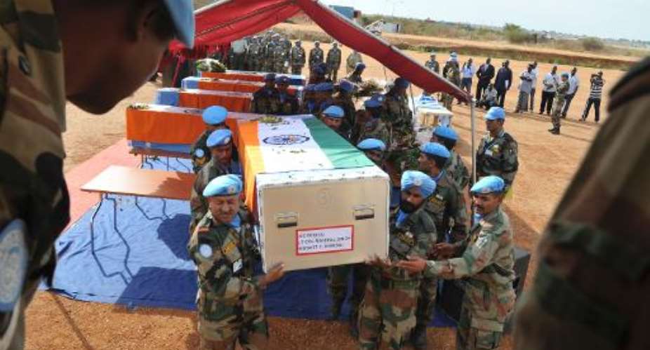 United Nations peacekeepers carry the coffin of one of the five Indian peacekeepers killed during an ambush in Jonglei, on April 10, 2013 in Juba during a funeral ceremony.  By Isaac Alebe Avoro AFPFile