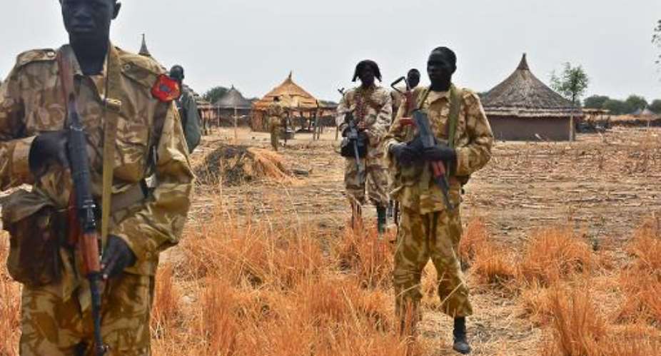 Sudan People's Liberation Army SPLA soldiers patrol a village in Mathiang, some 44 kilometers from Bor, on January 25, 2014.  By Charles Atiki Lomodong AFP