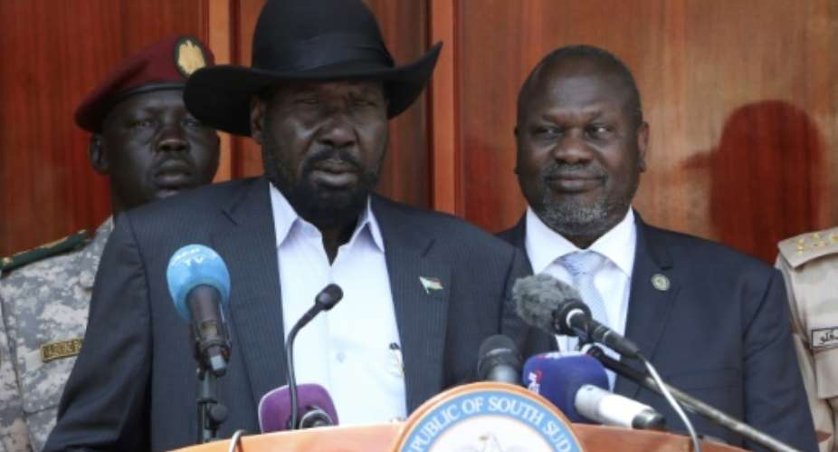South Sudan President Salva Kiir, centre, and former vice-president and political rival Riek Machar, pictured in February 2020. Their unity government remains fragile.  By PETER LOUIS AFP