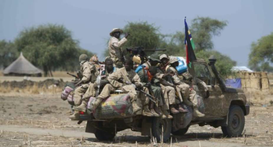 Armed South Sudanese government soldiers ride in a pickup truck near a village in Bor, on January 26, 2014.  By Ali Ngethi AFPFile
