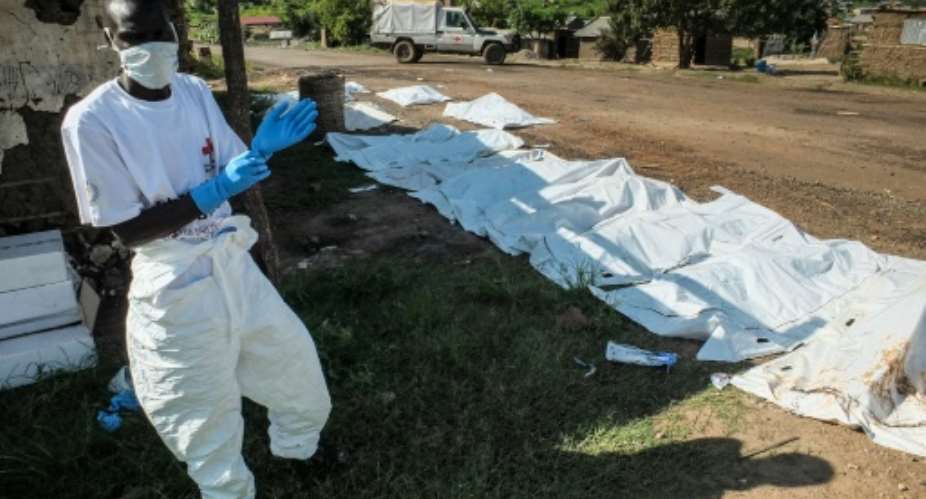 A South Sudanese ICRC International Red Cross Committee worker is seen next to body bags with the remains of victims of the past days violence in Juba, on July 16, 2016.  By Samir Bol AFPFile