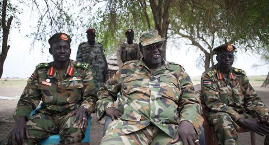 South Sudanese rebel leader and former vice president Riek Machar centre attends an interview in Nasir, on April 14, 2014.  By Zacharias Abubeker AFP