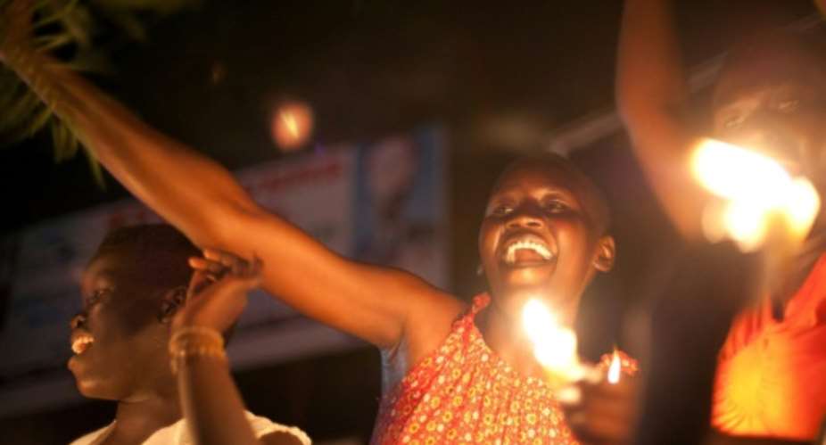 South Sudanese celebrate as the clock ticks over to midnight on July 9, 2011, the day South Sudan officially declared independence.  By PHIL MOORE AFP