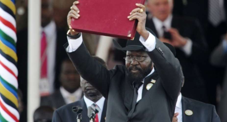 South Sudanese President Salva Kiir brandishes  the country's new constitution on July 9, 2011.  By Roberto SCHMIDT AFPFile